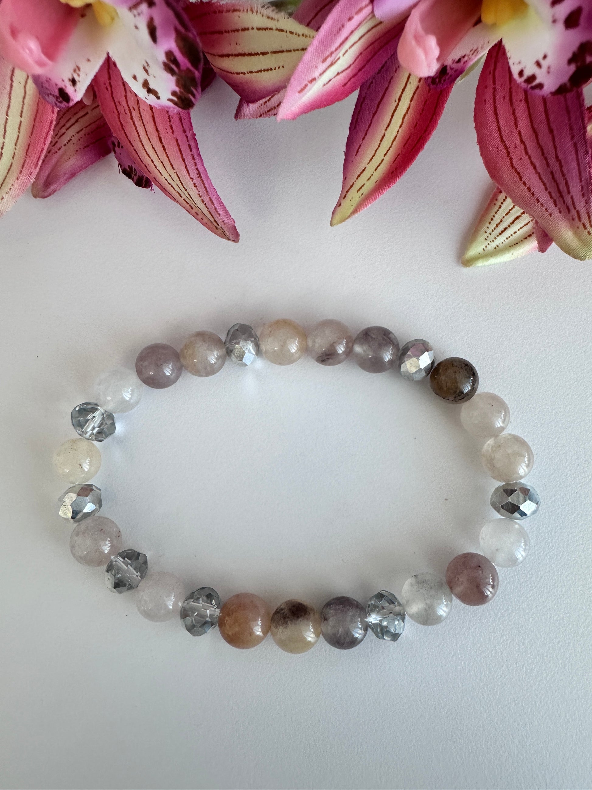 This delicate bracelet is handmade with a sterling silver HOPE pendant, 6 mm white silver rondelle Austrian crystal spacers, and 8 mm Morganite stretch beads. - Creations by Rosa