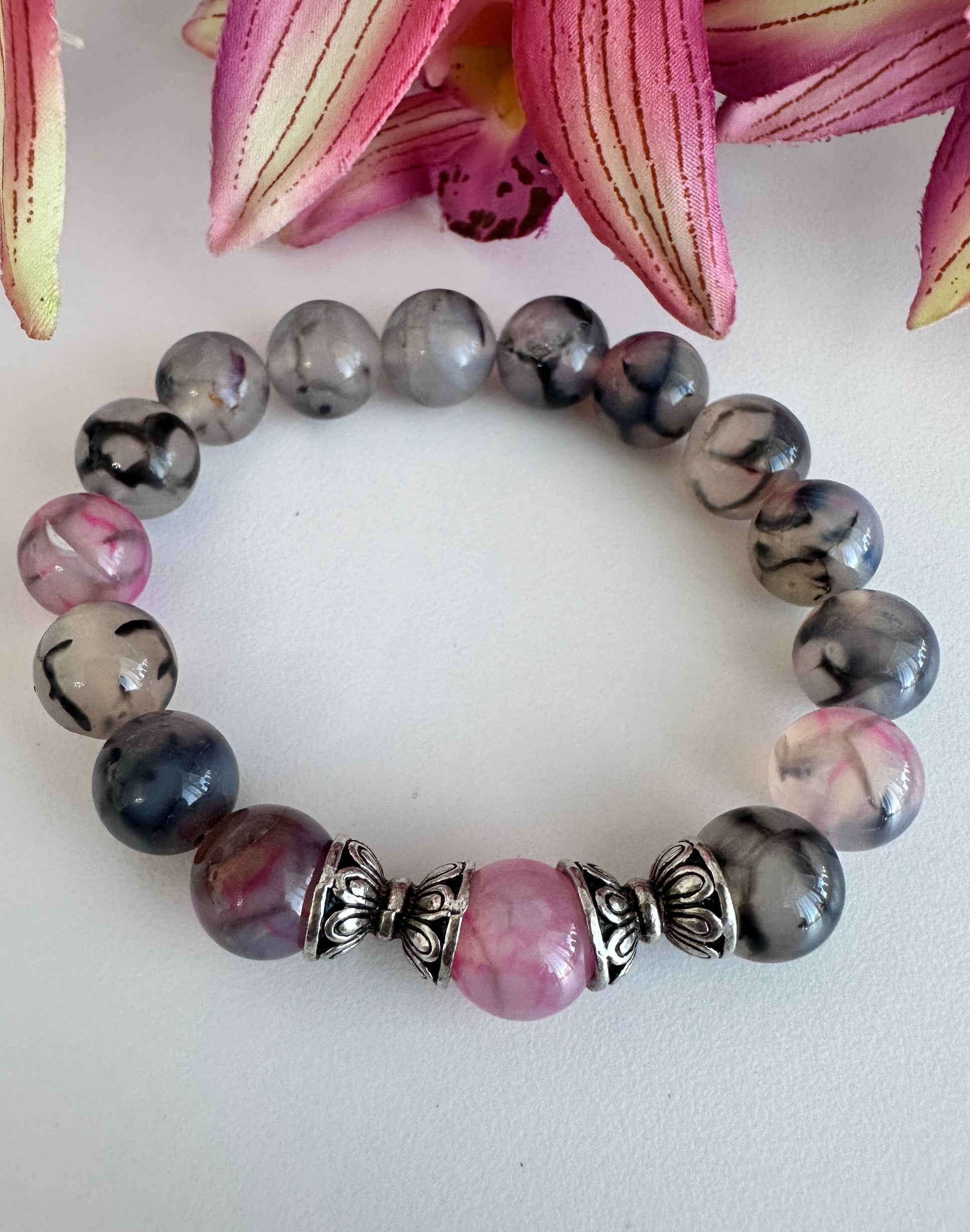 This handmade bracelet sports 10mm natural, high-grade beads, a secure stretchy cord, and a central agate dragon vein stone, complemented by two silver spacers. - Creations by Rosa