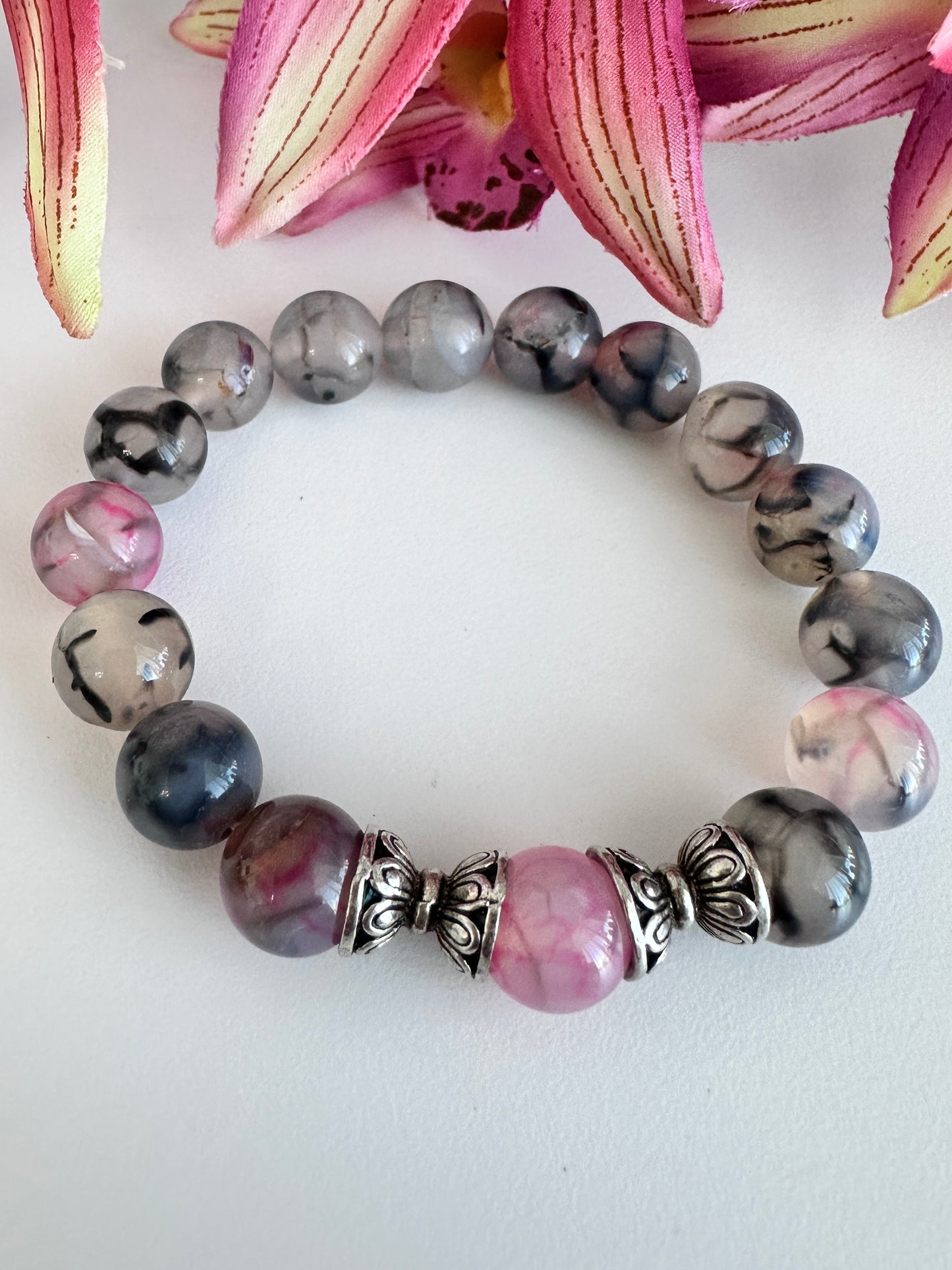 This handmade bracelet sports 10mm natural, high-grade beads, a secure stretchy cord, and a central agate dragon vein stone, complemented by two silver spacers. - Creations by Rosa