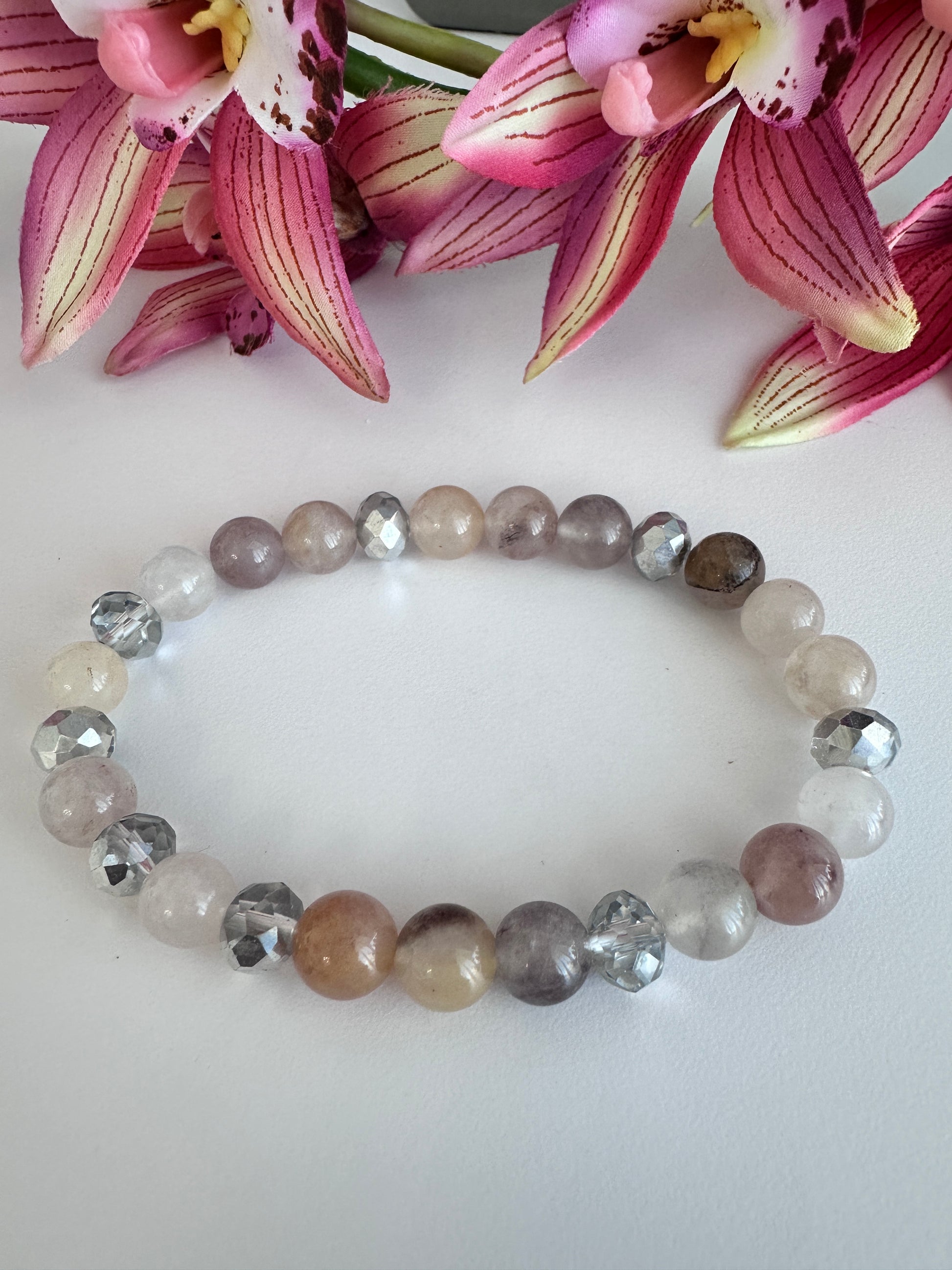 This delicate bracelet is handmade with a sterling silver HOPE pendant, 6 mm white silver rondelle Austrian crystal spacers, and 8 mm Morganite stretch beads. - Creations by Rosa