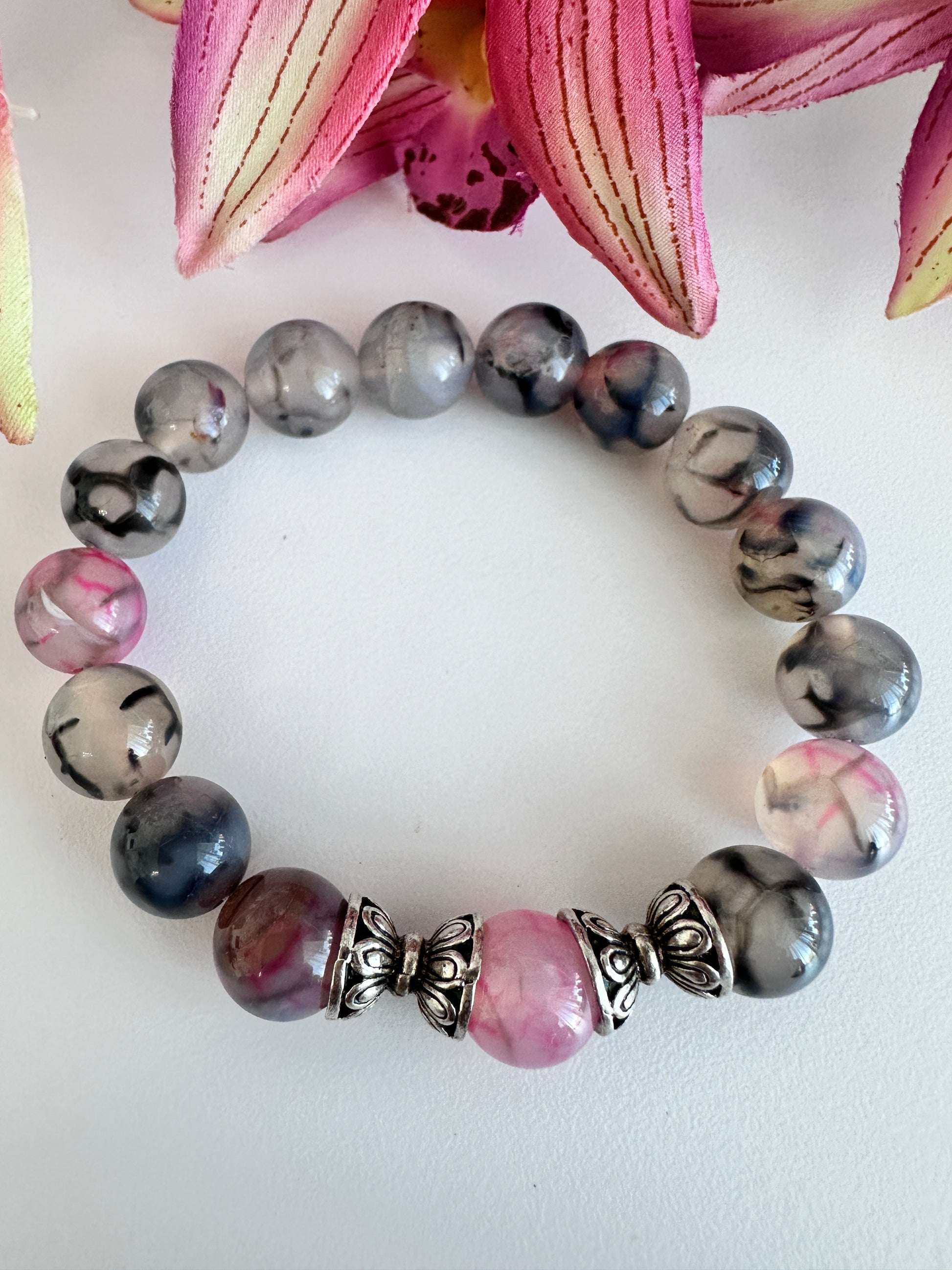 This handmade bracelet sports 10mm natural, high-grade beads, a secure stretchy cord, and a central agate dragon vein stone, complemented by two silver spacers. - Creations by Rosa