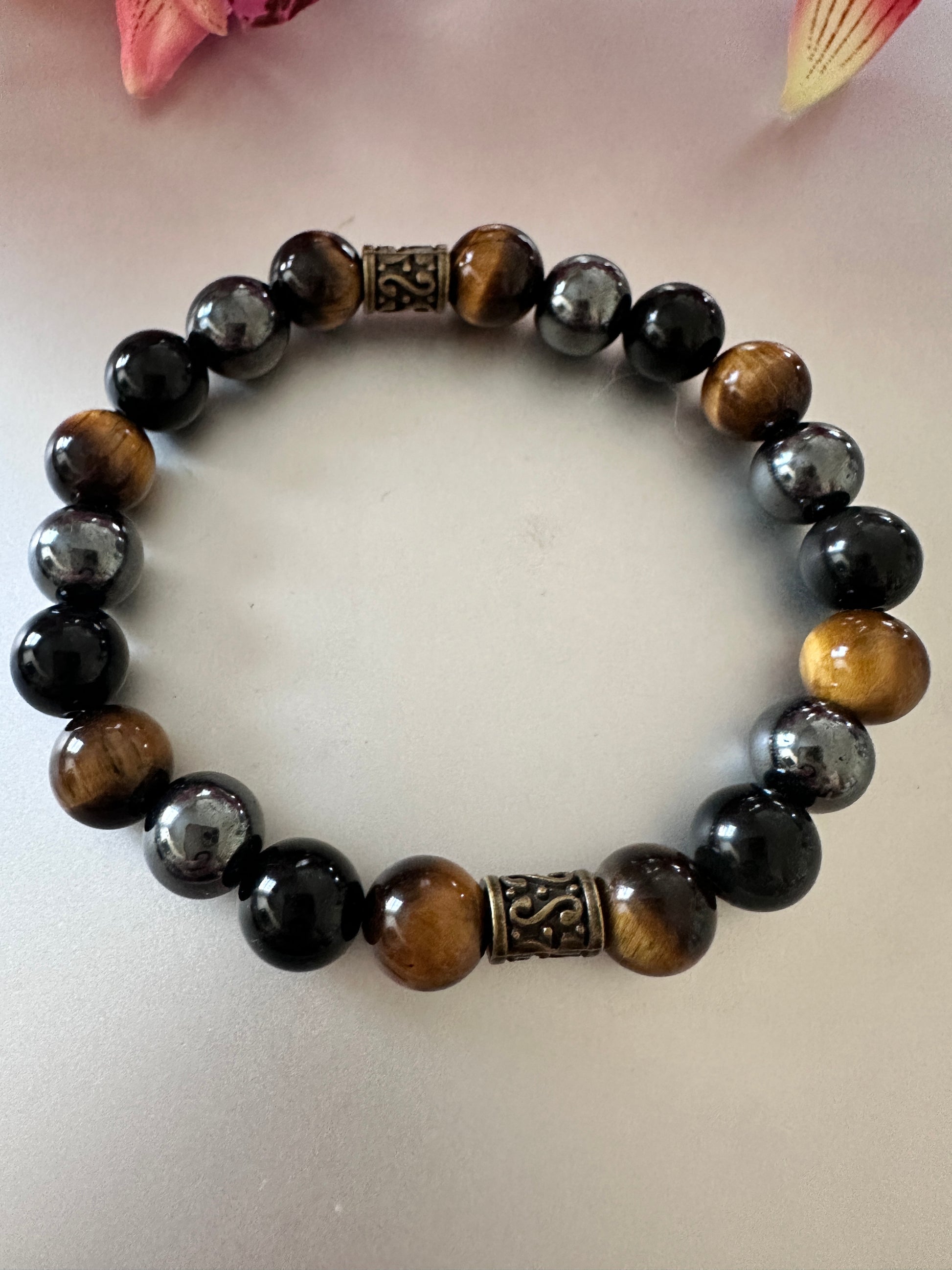 This bracelet has tigers, eye hematite, and black onyx - Creations by Rosa