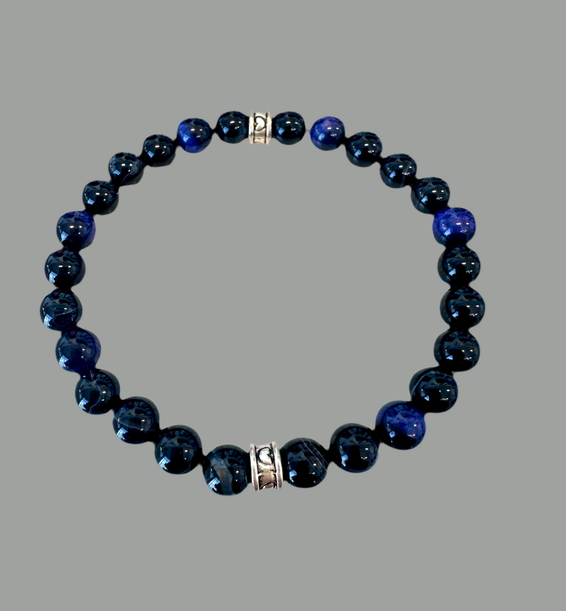 stretch bracelet features raw Black Chalcedony and Tigers Eye beads.