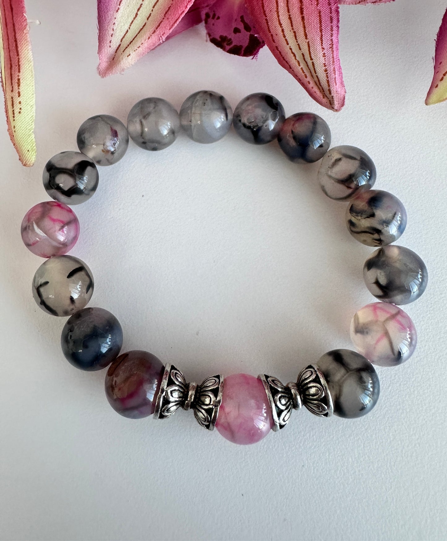 This handmade bracelet sports 10mm natural, high-grade beads, a secure stretchy cord, and a central agate dragon vein stone, complemented by two silver spacers. - Creations by Rosa