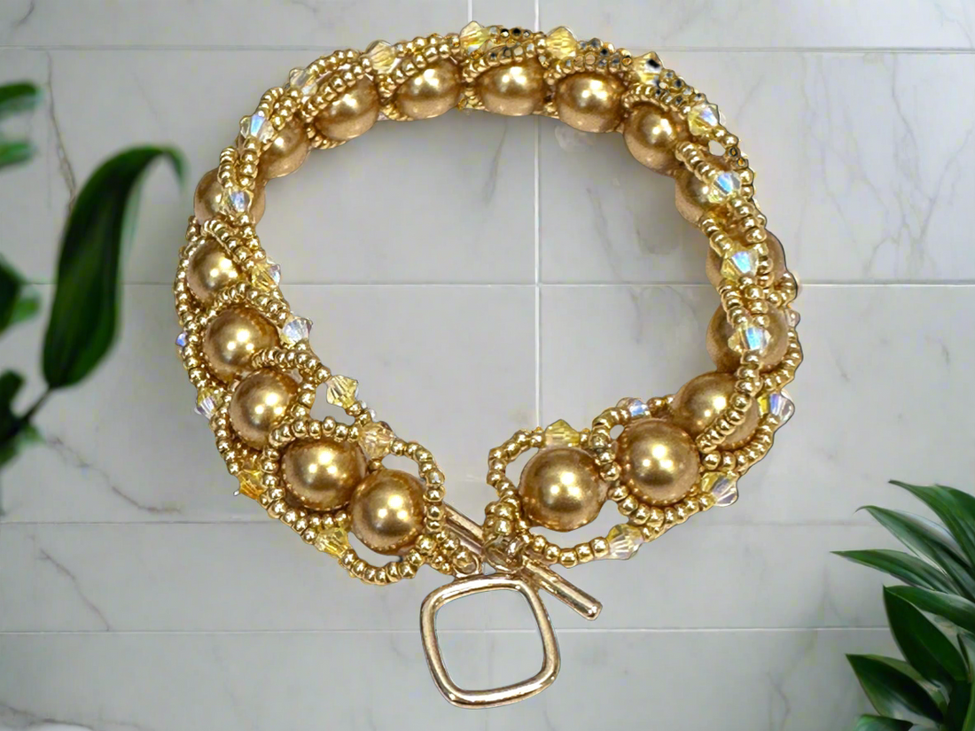 Flat Spiral bracelet with Swarovski pearls an 18 karat plated toggle clasp