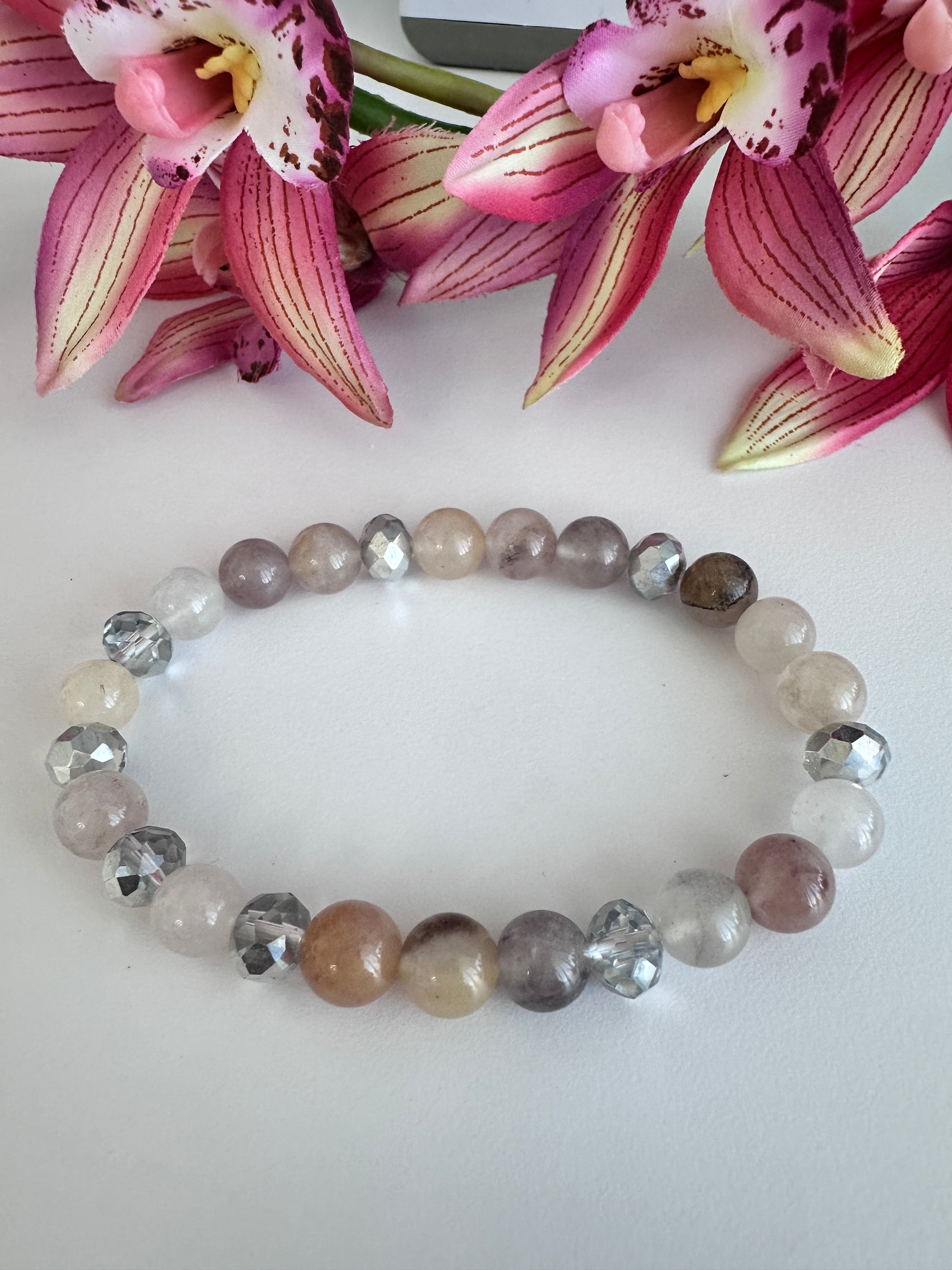 This delicate bracelet is handmade with a sterling silver HOPE pendant, 6 mm white silver rondelle Austrian crystal spacers, and 8 mm Morganite stretch beads. - Creations by Rosa