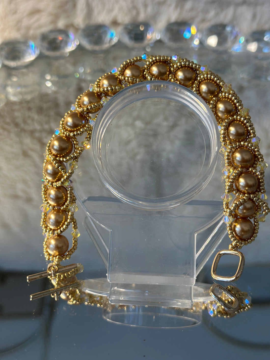 Flat Spiral bracelet with Swarovski pearls an 18 karat plated toggle clasp