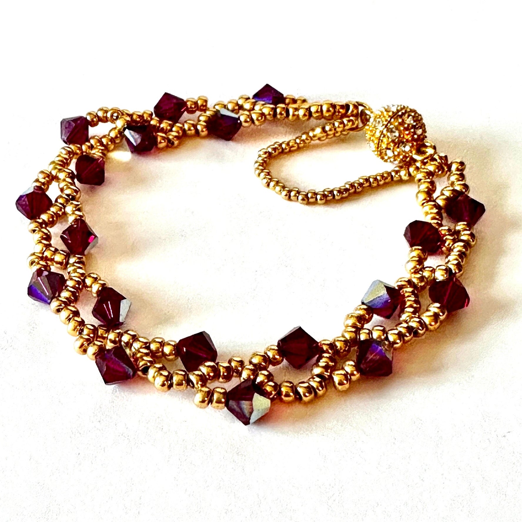 This Ruby Swarovski Crystal bicone Vine Bracelet is crafted using Gold Miyuki seed beads